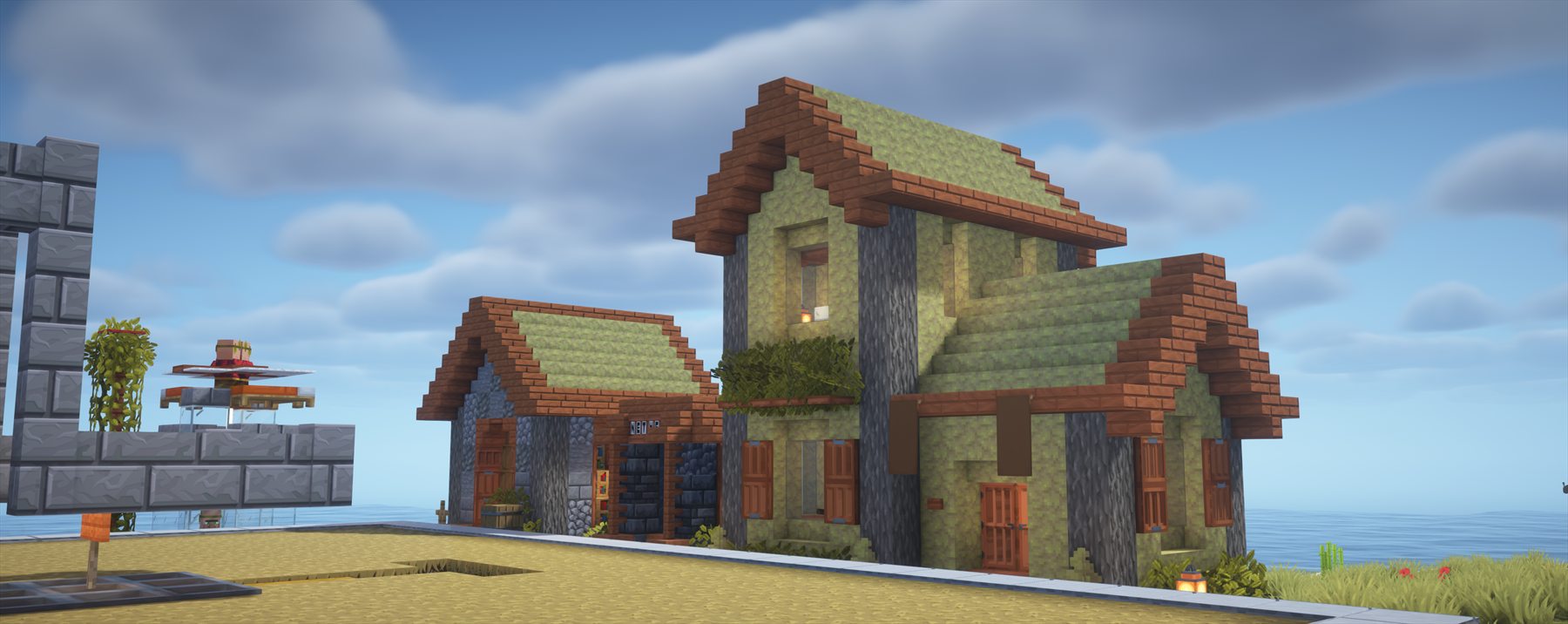 Dos casas de madera y piedra frente al mar