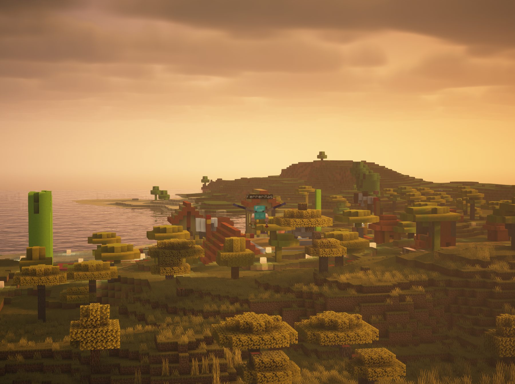 Vista del mundo de Cubusfera al atardecer, con casas junto a la costa